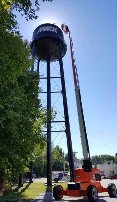 A large water tower with a crane attached to it.