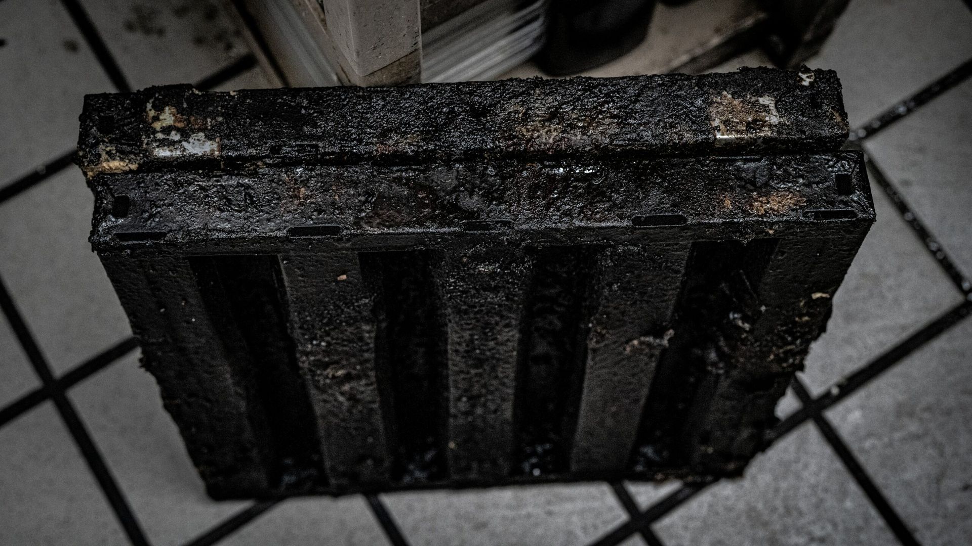 A Black Object Is Sitting on A Tiled Floor | S. Glens Falls, NY | Performance Industrial