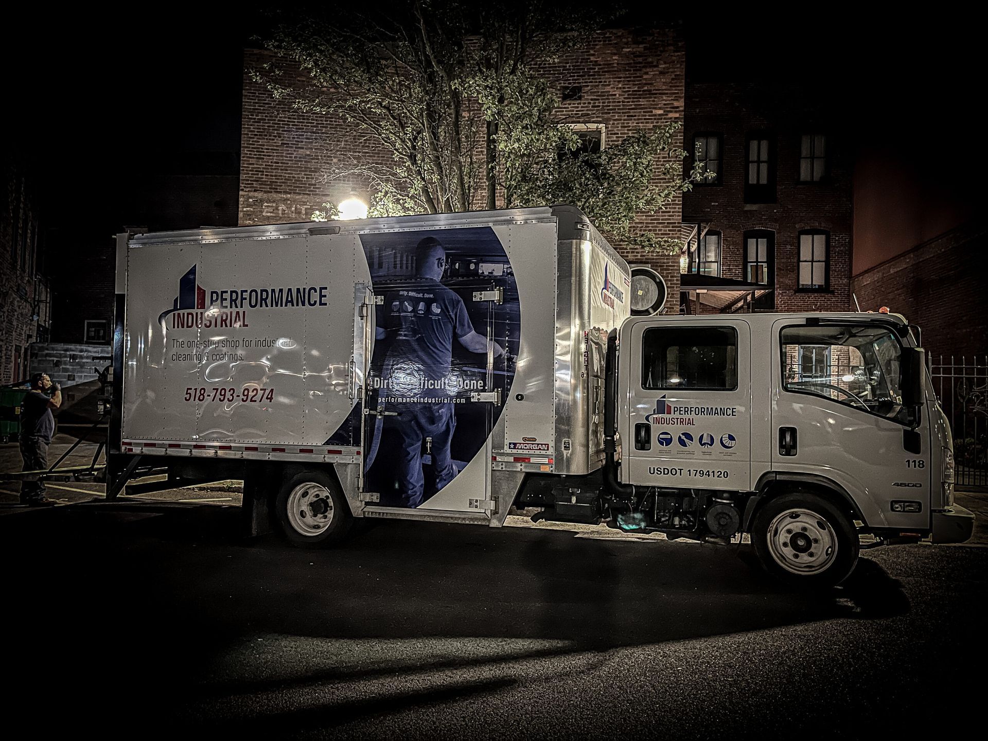 A White Truck Is Parked on The Side of The Road at Night | S. Glens Falls, NY | Performance Industrial