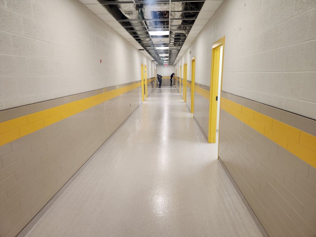 A long hallway with yellow stripes on the walls