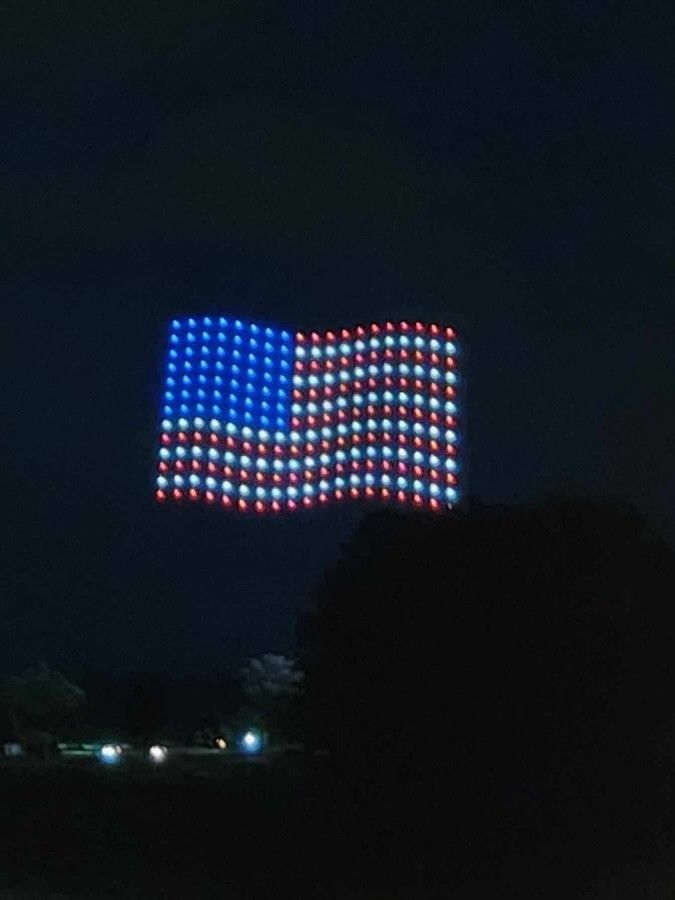 A large american flag is lit up at night