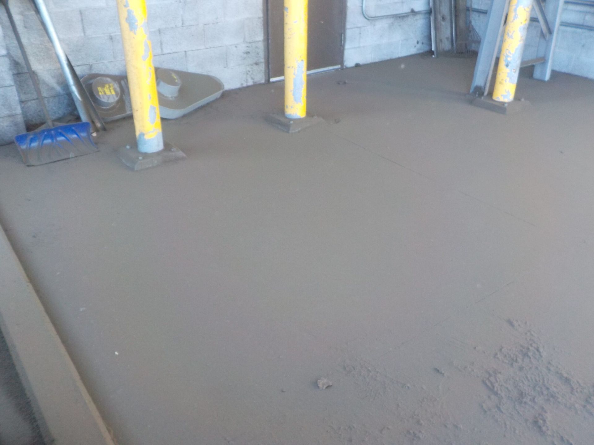 A Dirty Floor with Yellow Poles and A Broom on It | S. Glens Falls, NY | Performance Industrial