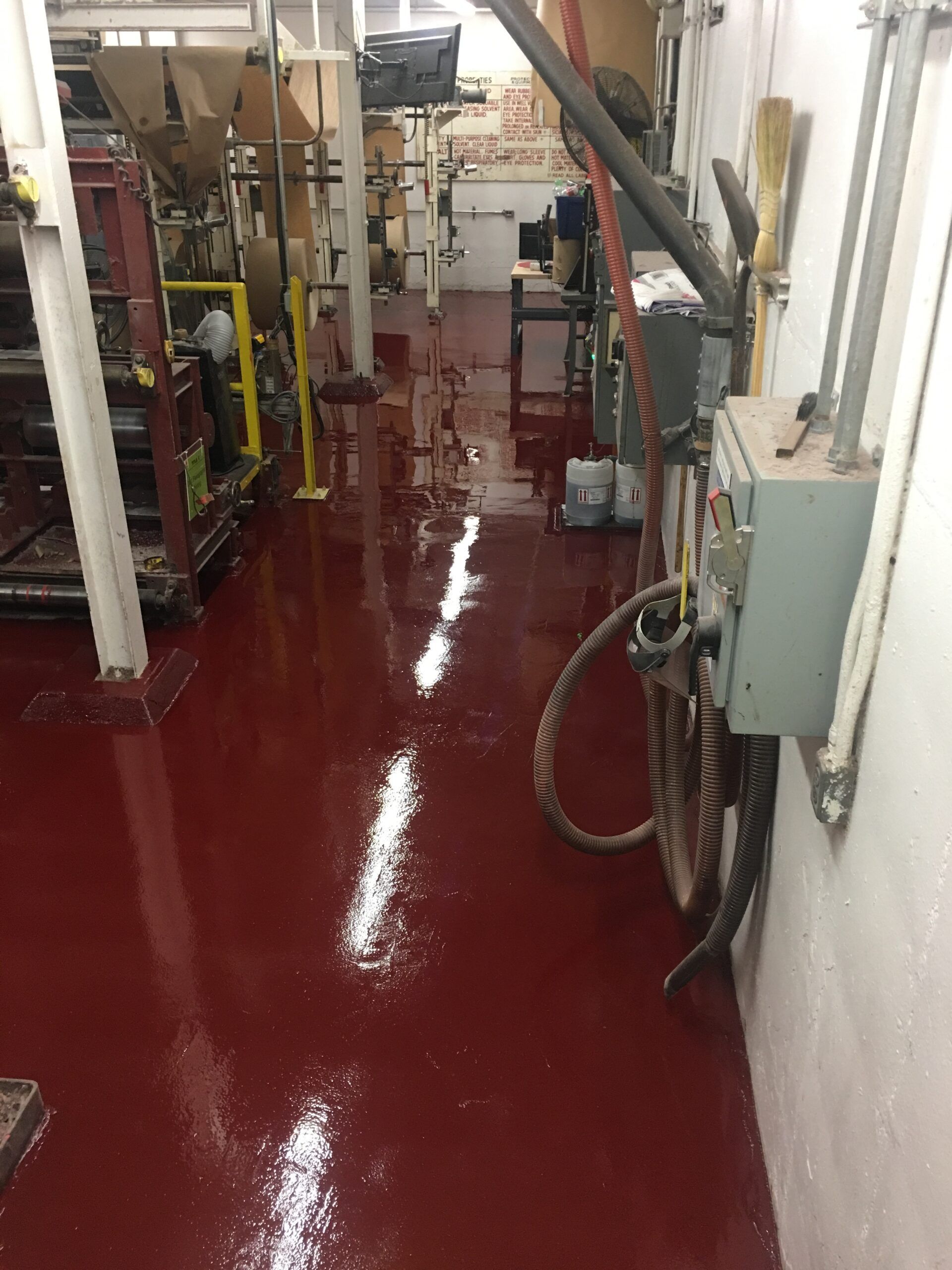 A room with a red floor and a white wall.