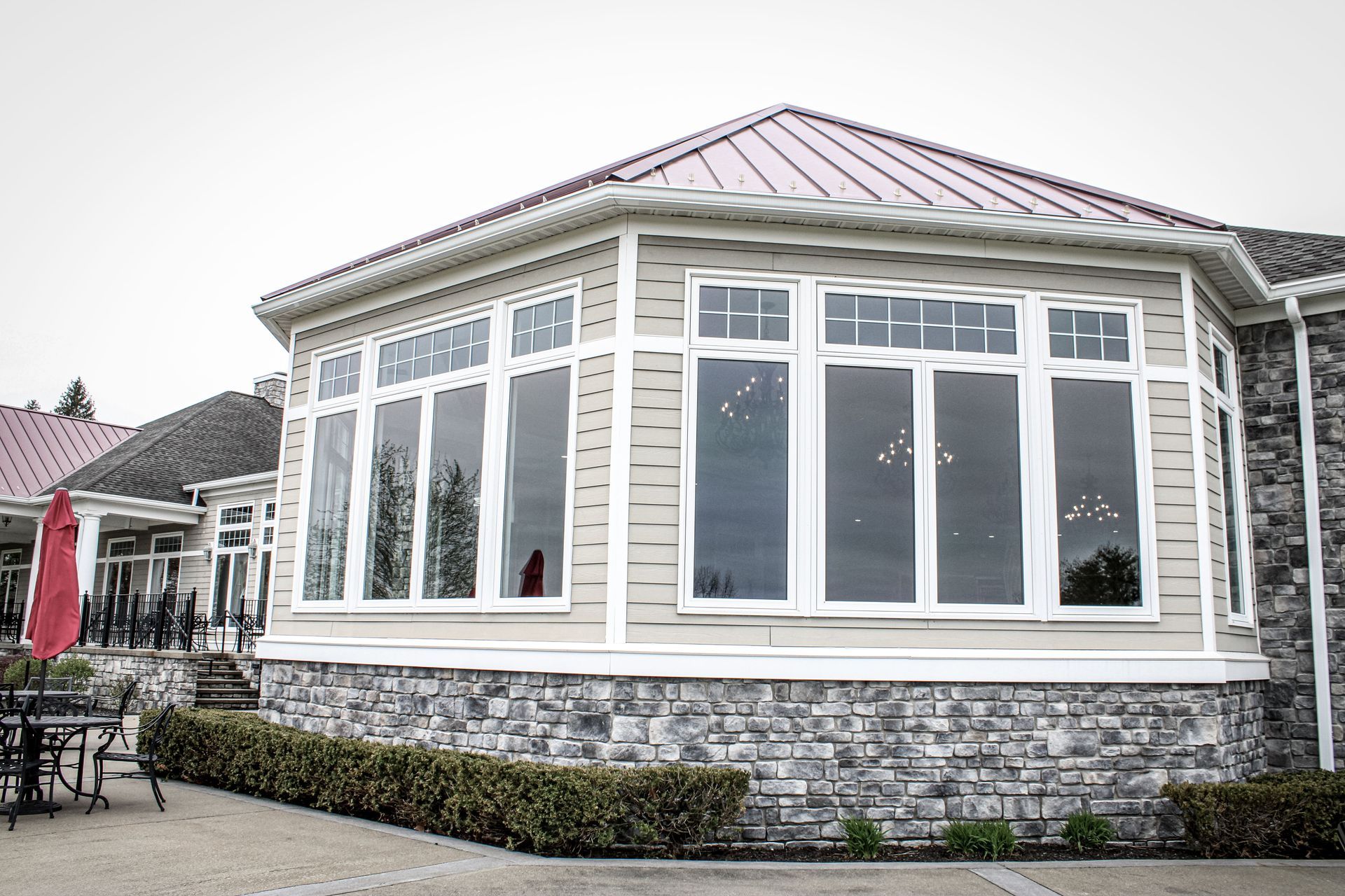 A large house with a red roof and a lot of windows