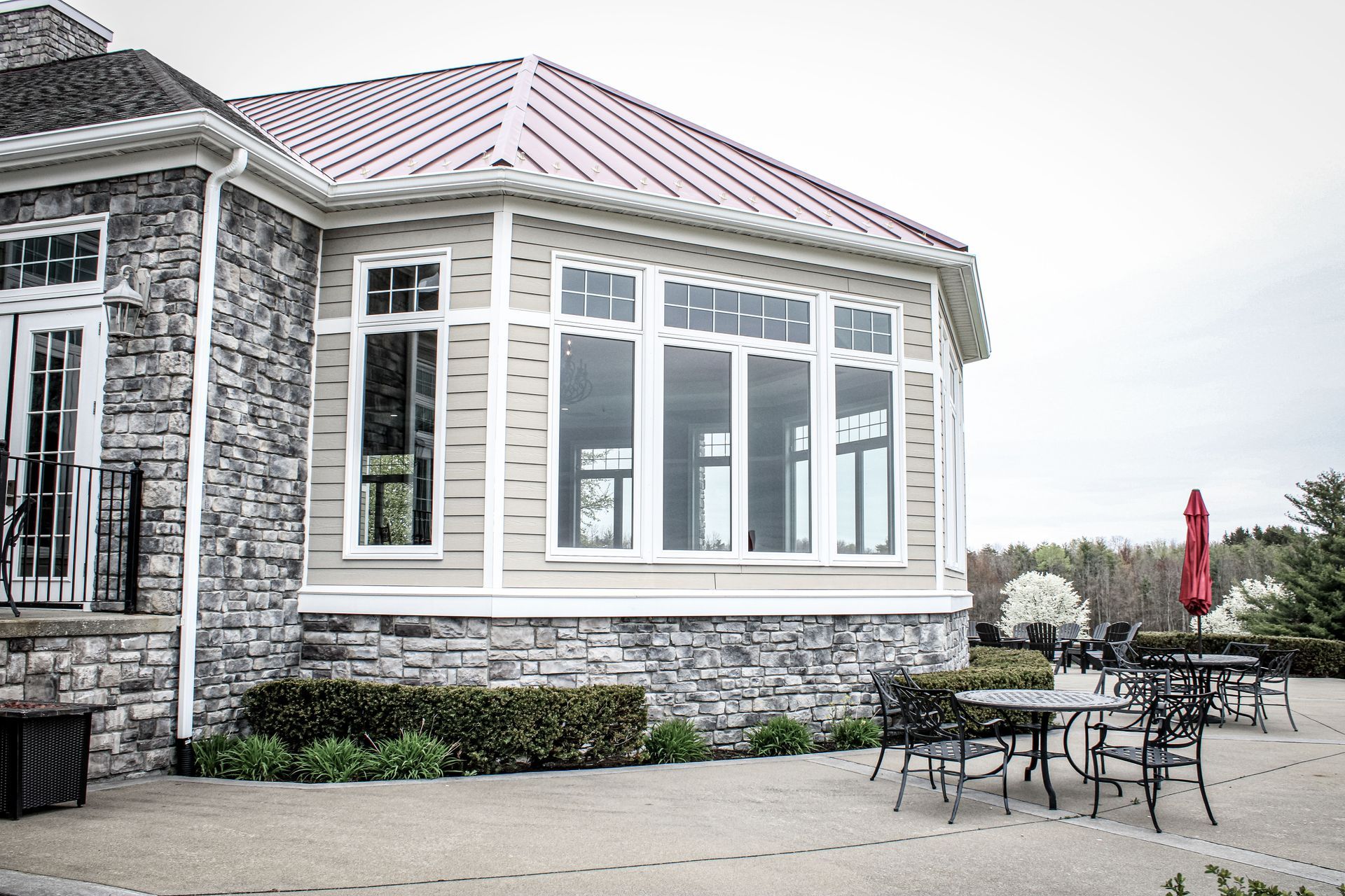 A house with a red roof and a lot of windows