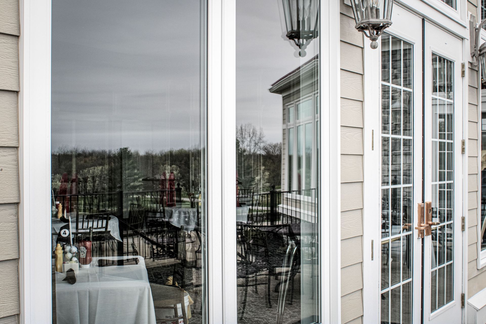 A house with a lot of windows and a table in front of it.