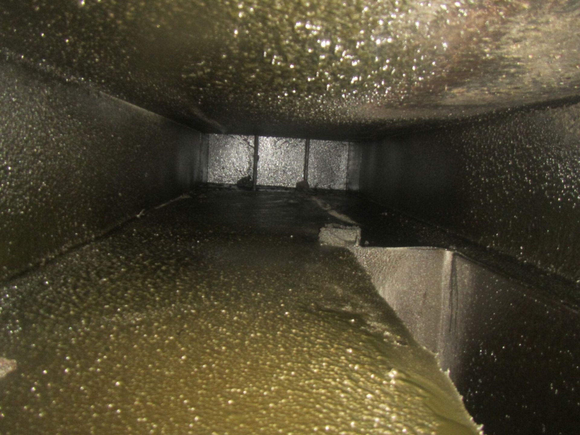 A dirty air vent with a lot of dust on it.