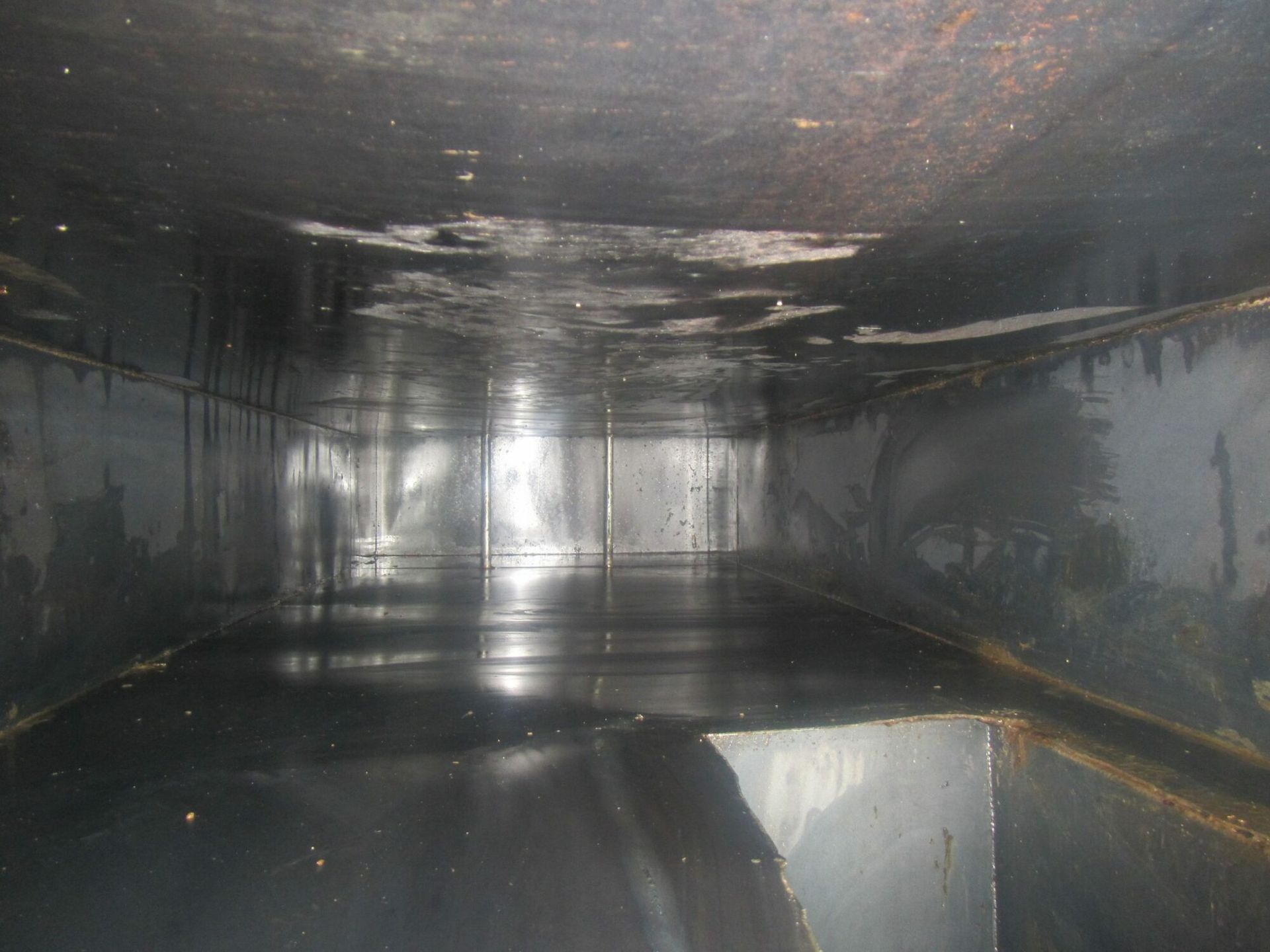 The inside of a large metal container with a lot of water in it.
