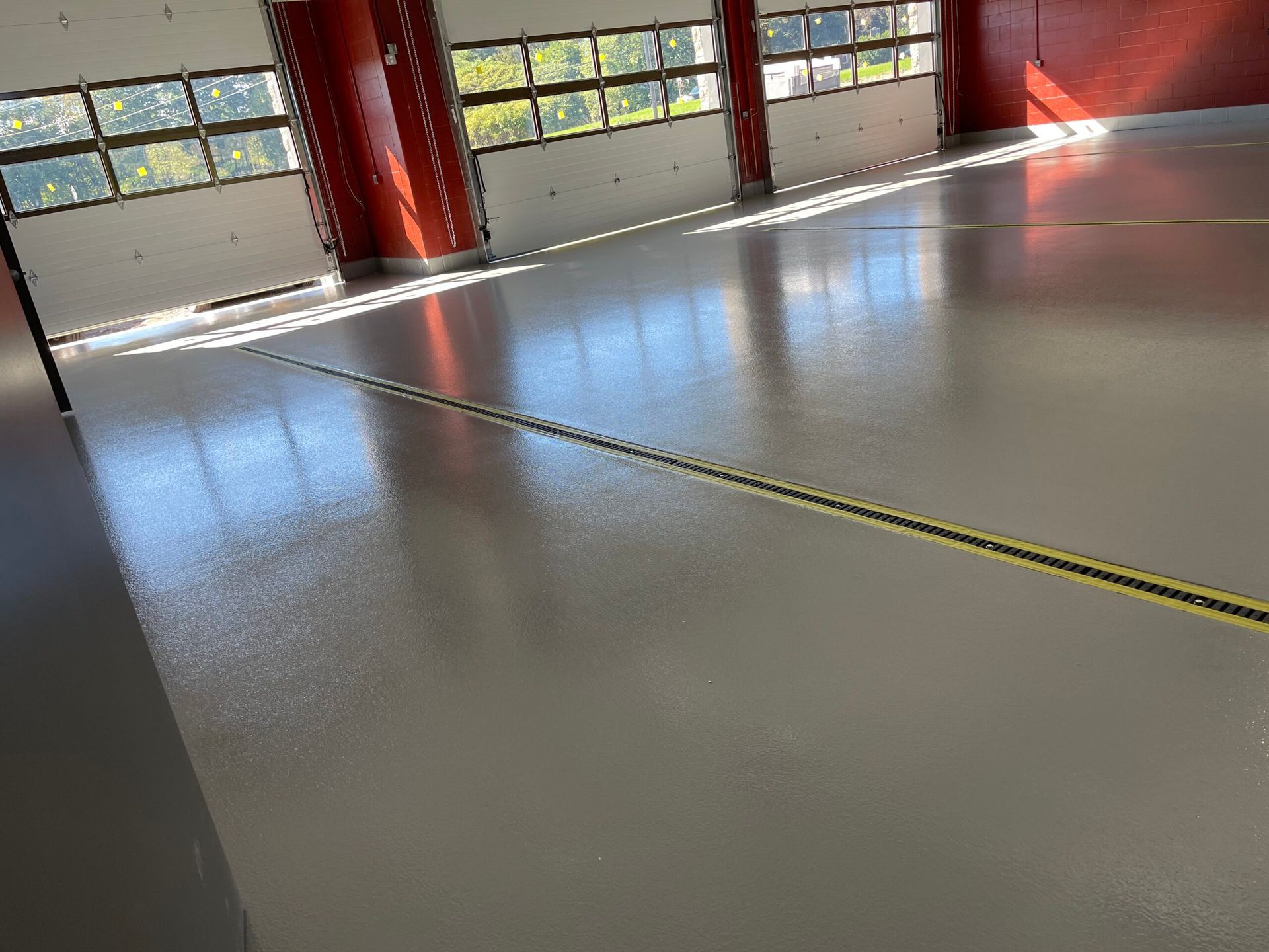 A large empty garage with a yellow line on the floor.