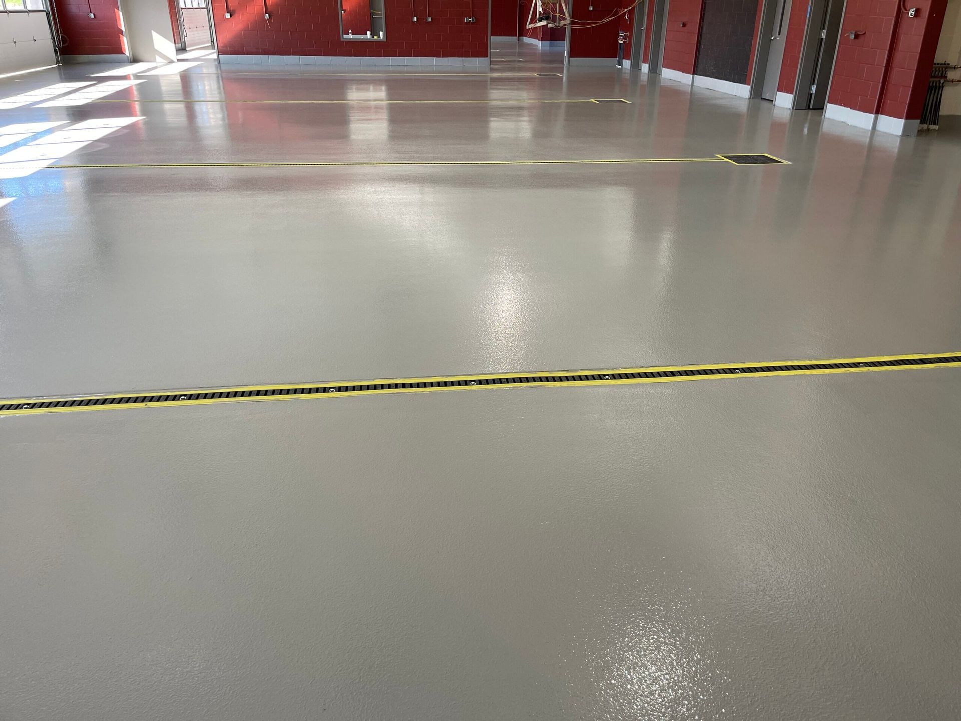 A gray floor with a yellow line on it