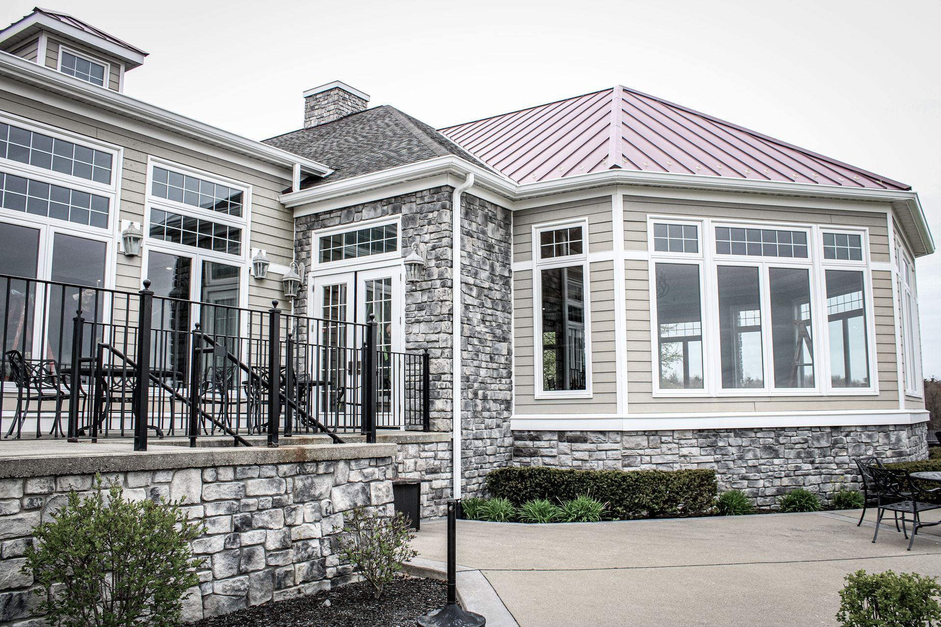A large house with a red roof and a lot of windows