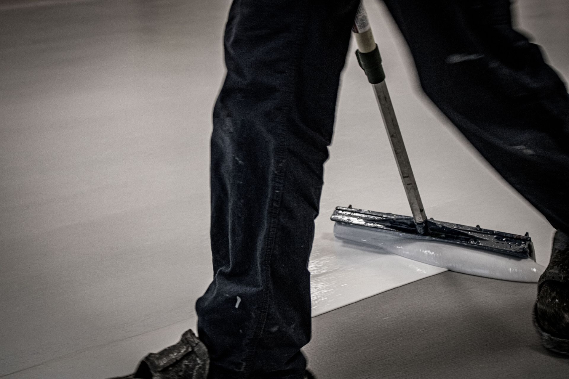 A person is cleaning the floor with a mop.