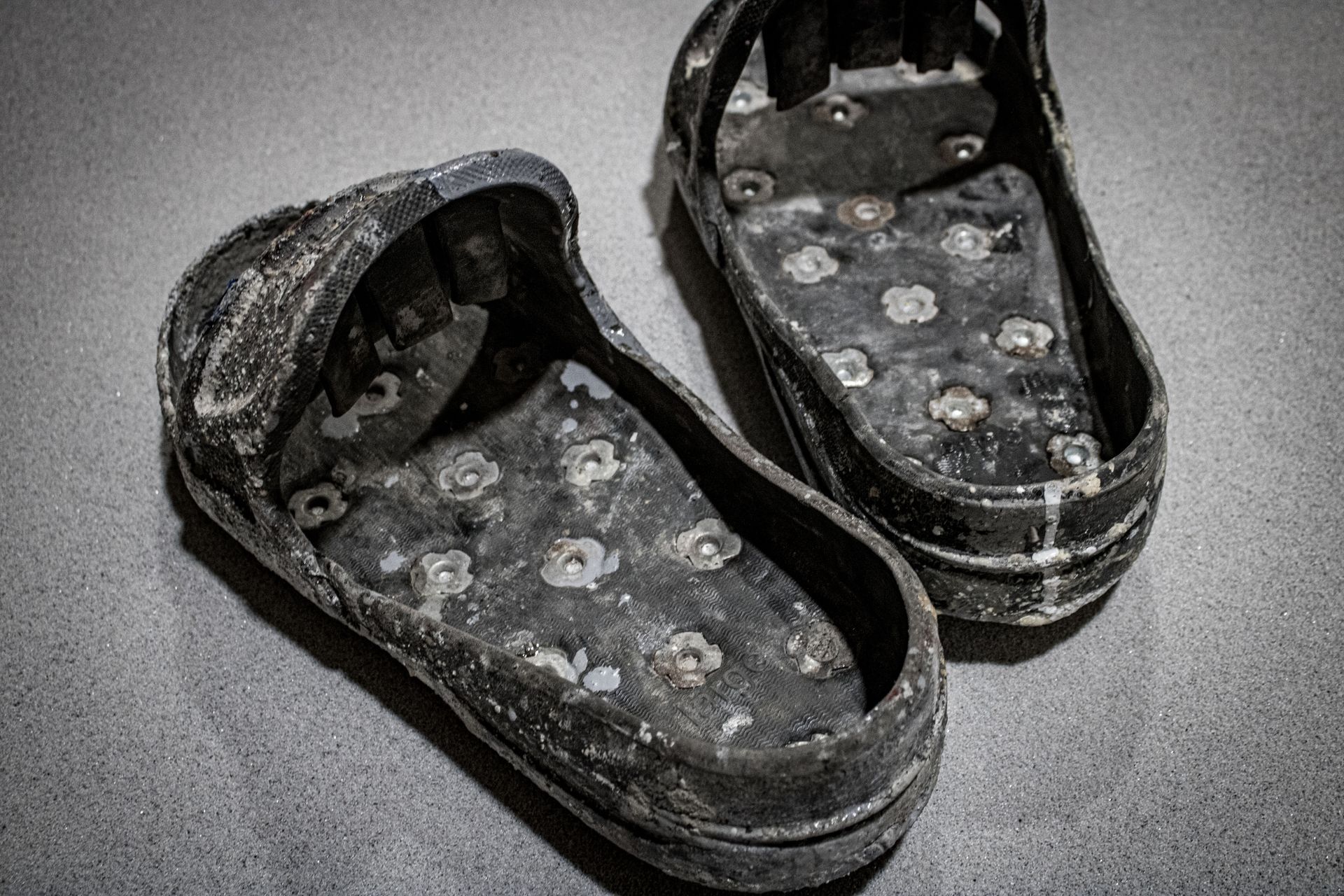 A pair of dirty shoes are sitting on a table.