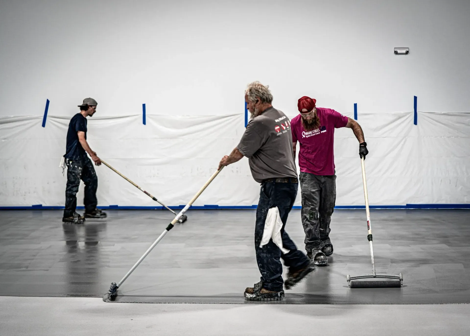 A Group of Men Are Painting a Concrete Floor | S. Glens Falls, NY | Performance Industrial