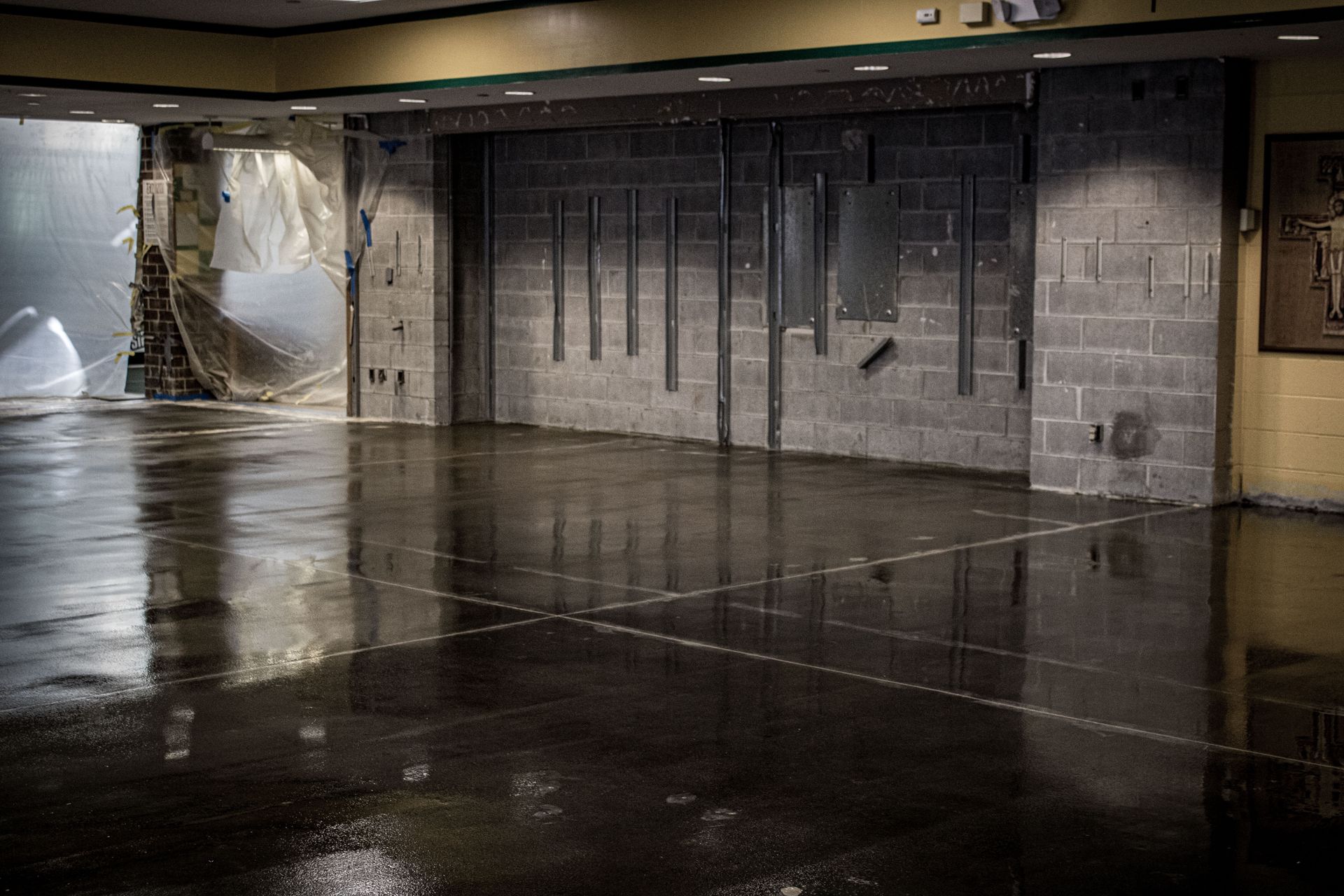 An empty room with a brick wall and a concrete floor.