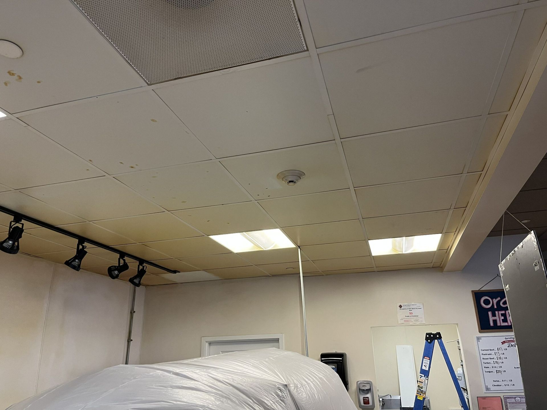 A room with a ladder and a sign that says order here