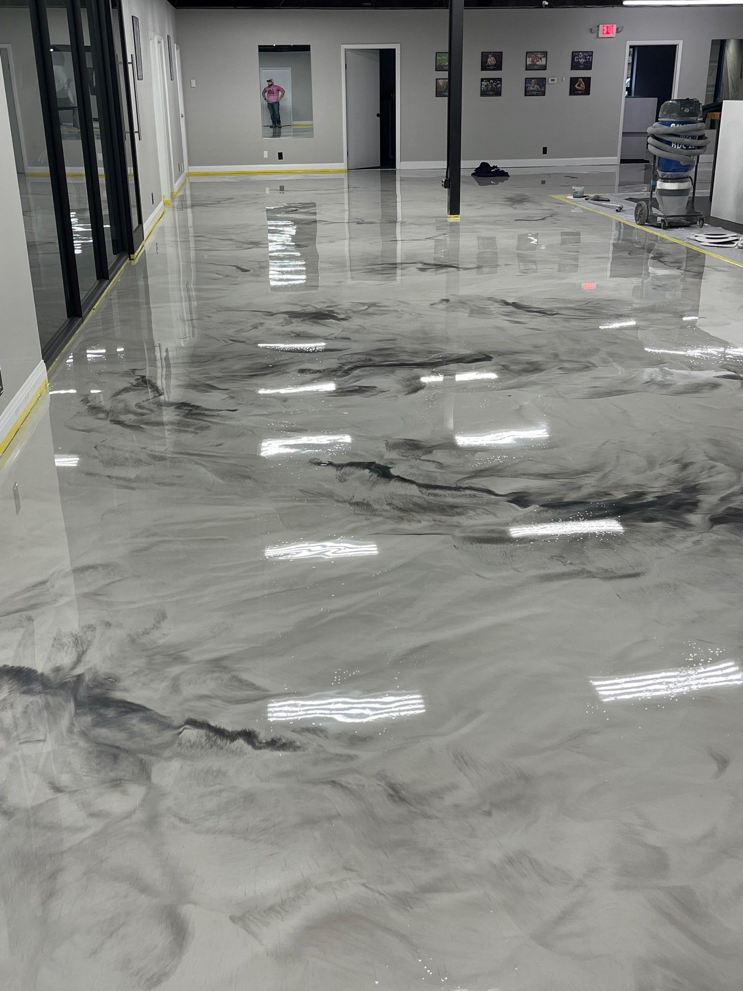 A large room with a marble floor and a vacuum cleaner.