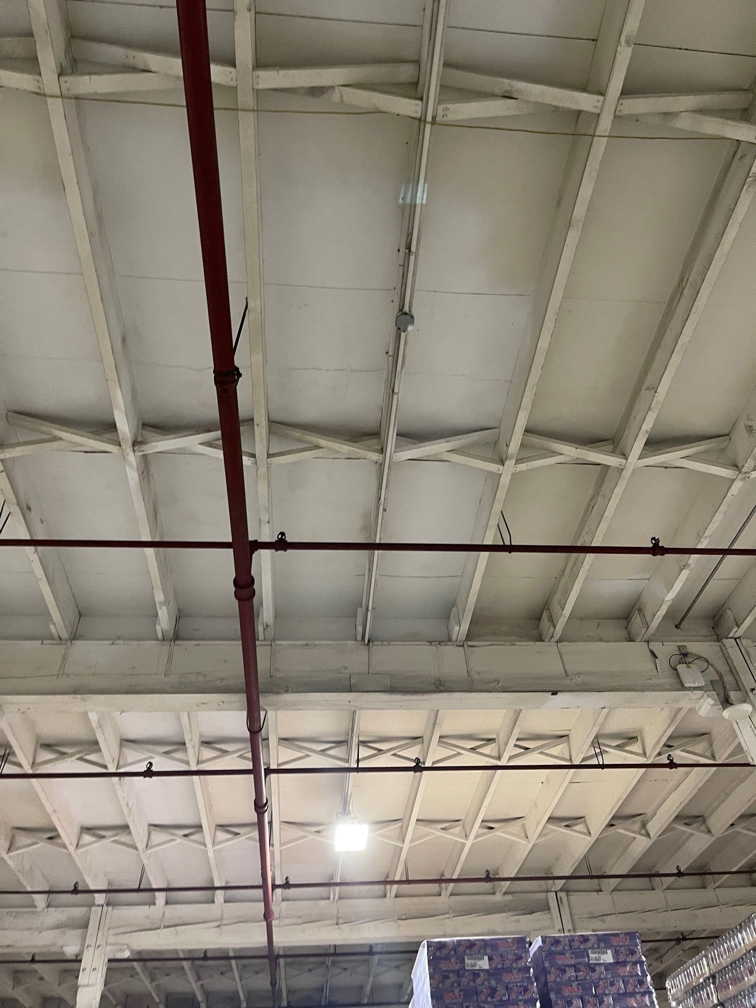 The Ceiling of A Building with A Red Pipe Hanging from It | S. Glens Falls, NY | Performance Industrial