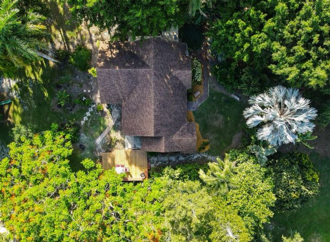 An aerial view of a house surrounded by trees.