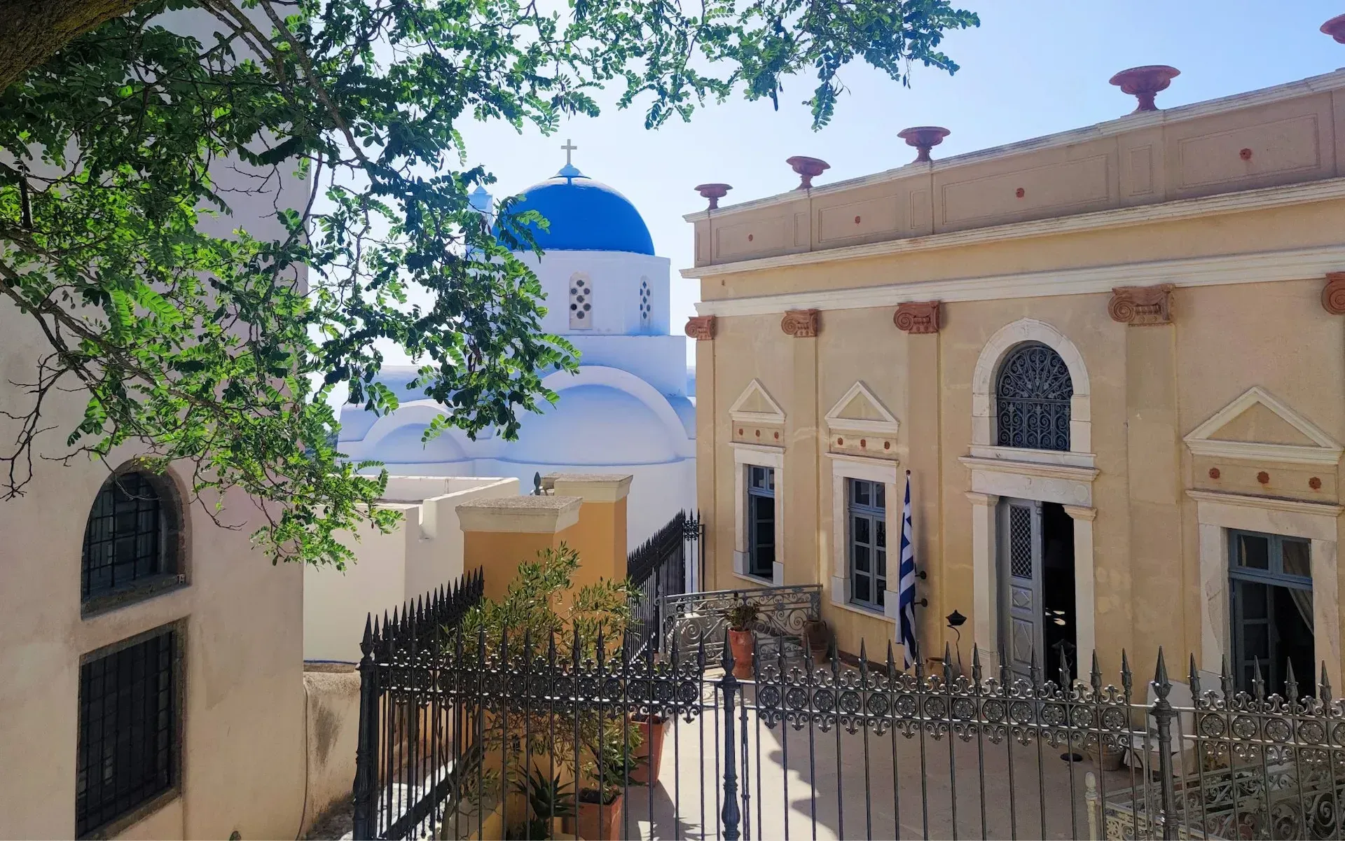 Quiet alley in Pyrgos with whitewashed walls and blue doors