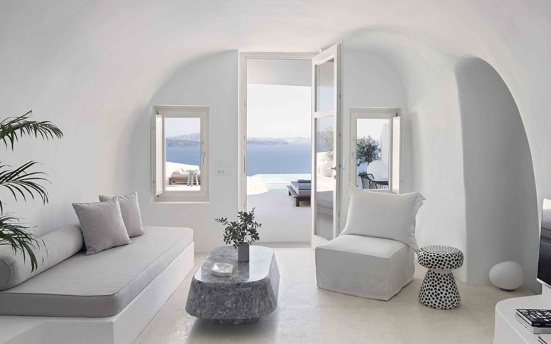 A luxury hotel room digged into the cliff with caldera view