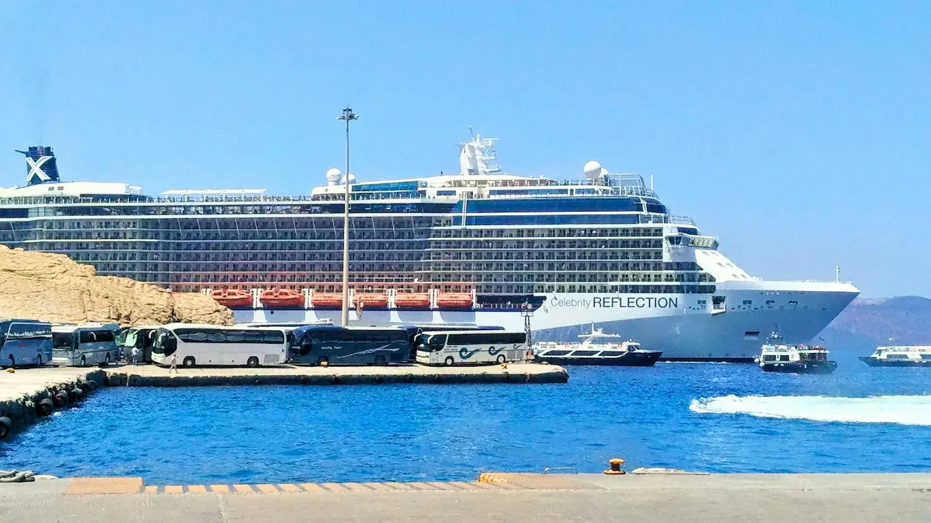 Tender boats below Fira and caldera cliffs