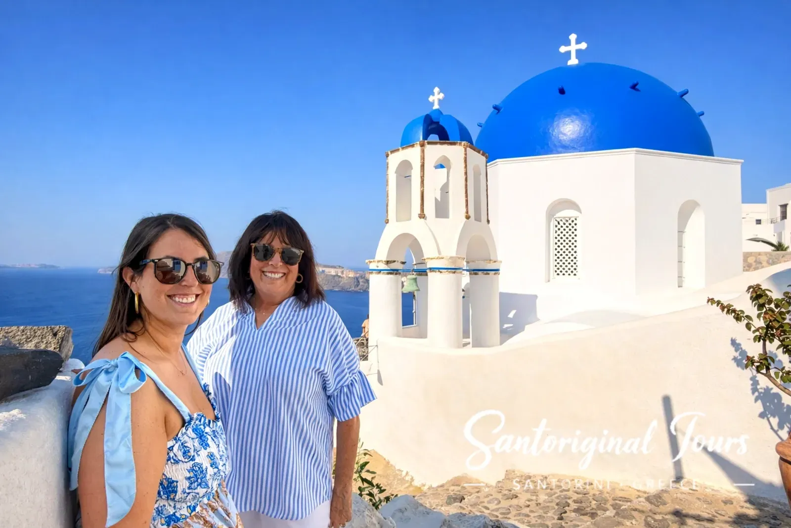 Guests enjoying a Santorini blue dome photo stop on a private tour