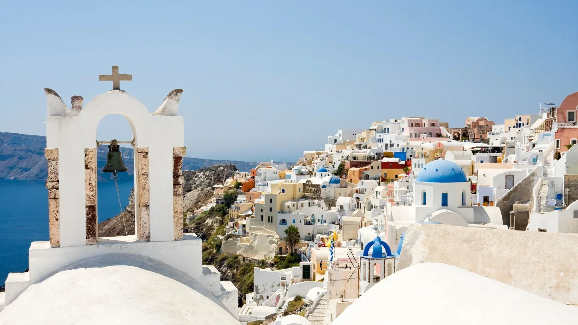 Santorini caldera view with whitewashed villages and blue domes