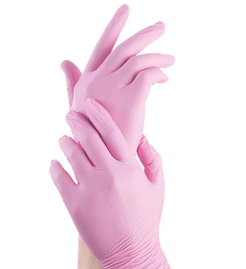 Hands in pink examination gloves.
