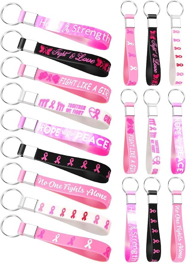 Collection of breast cancer awareness ribbon keychains in various colors and designs.