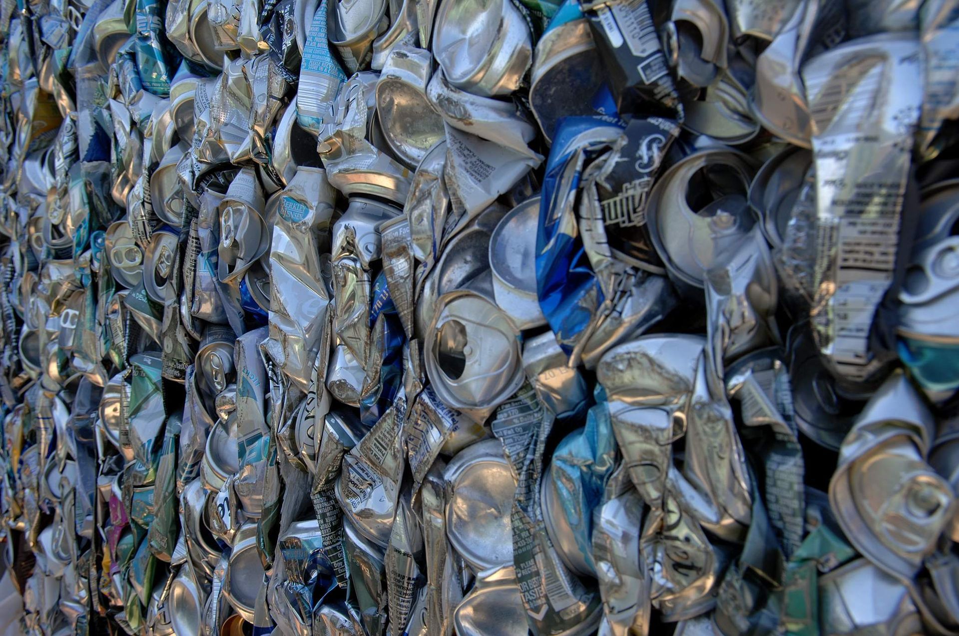 A pile of crushed aluminum cans stacked on top of each other