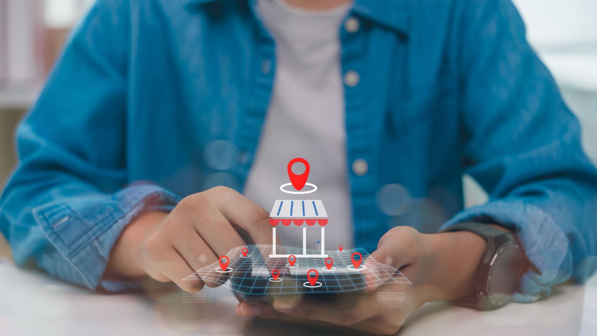 Person holding phone, shop icon with location marker floating above, red and white, blurred background. Person holding phone, shop icon with location marker floating above, red and white, blurred background.