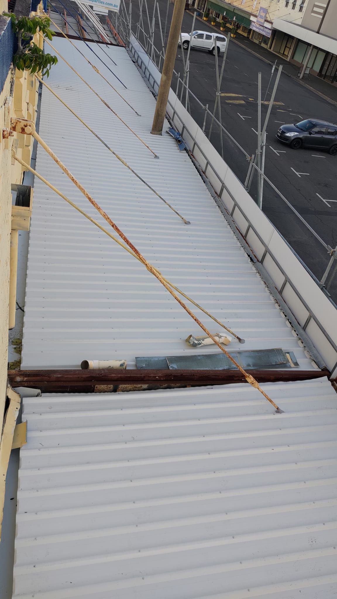 A High-angle View of a Grey Corrugated Metal Roof — Rhettro Roofing Industry in Taroomball, QLD