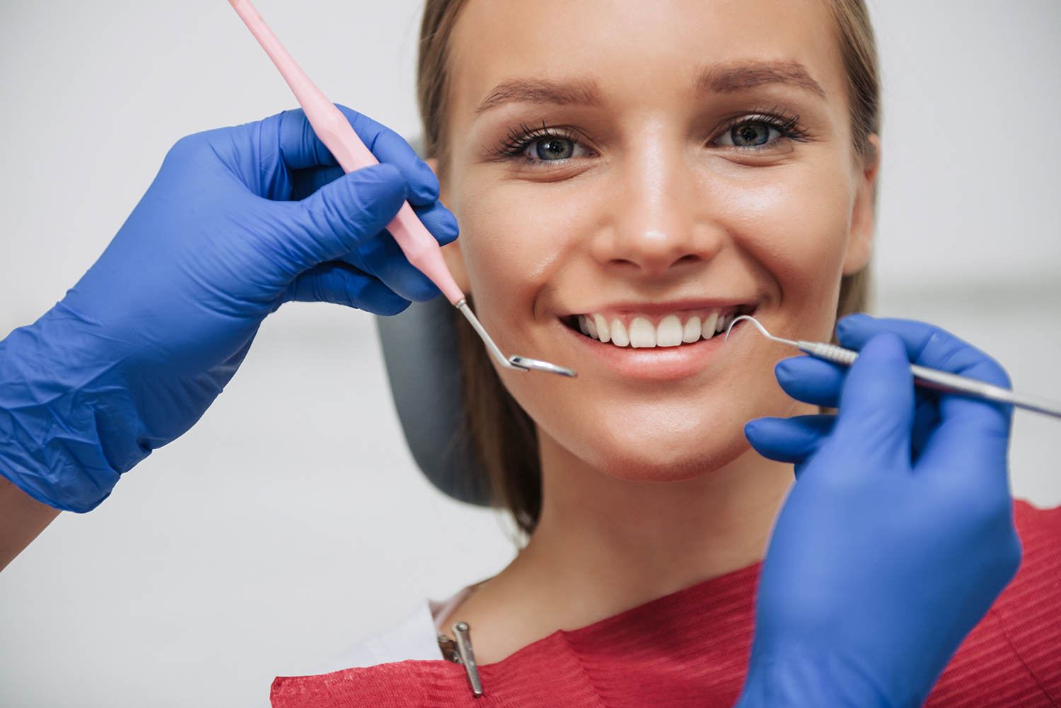 a woman is getting her teeth inspected while at her first dental visit with Dr. Lim