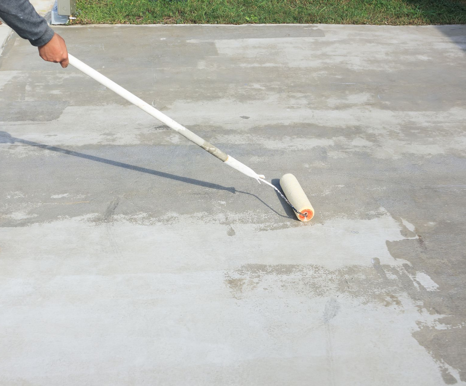 A group of construction workers are working on a concrete walkway.