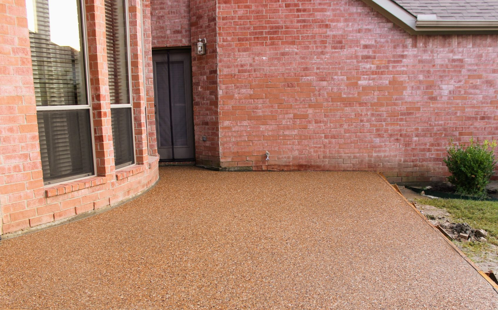 A group of construction workers are working on a concrete walkway.