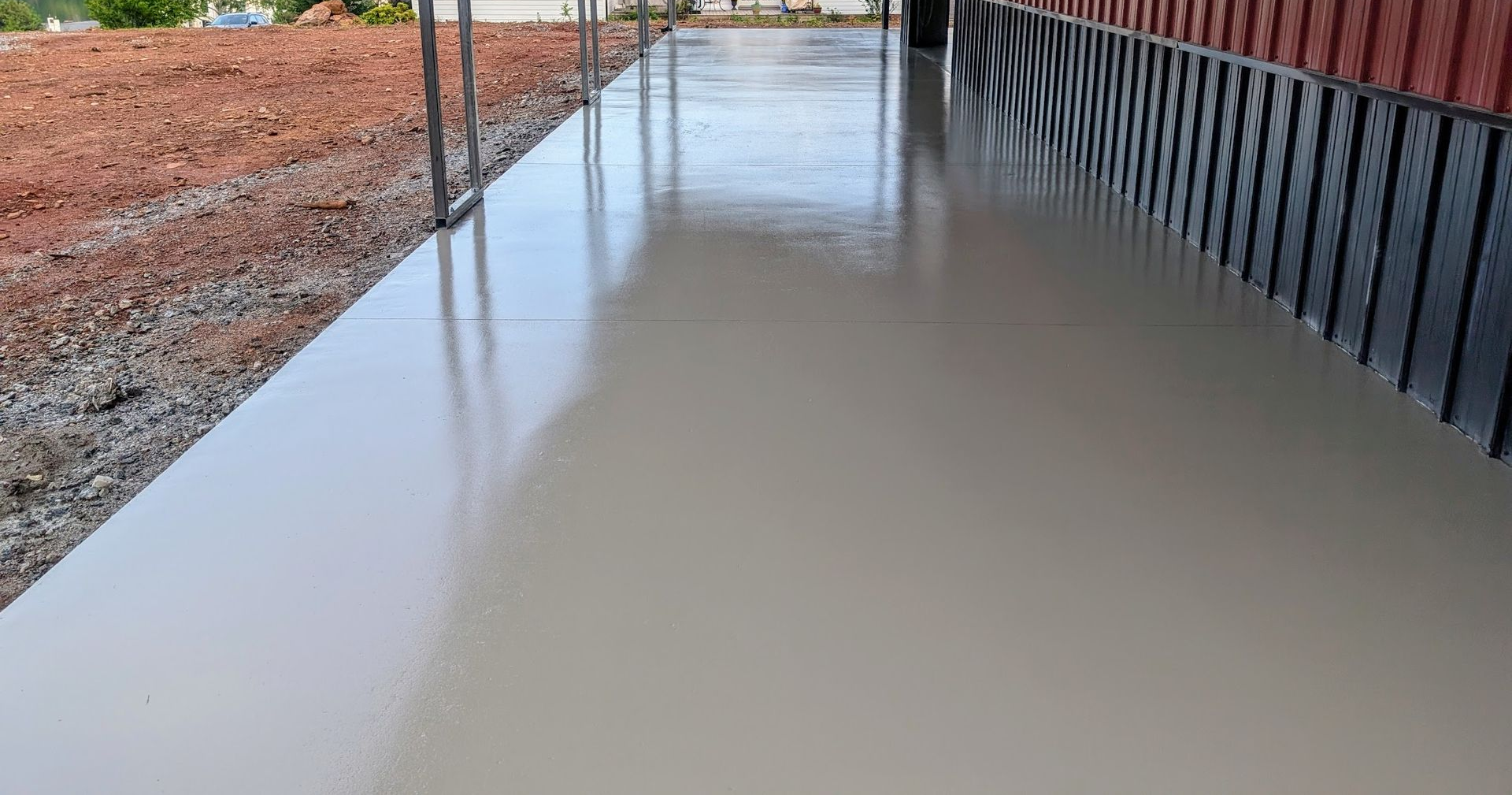 A group of construction workers are working on a concrete walkway.