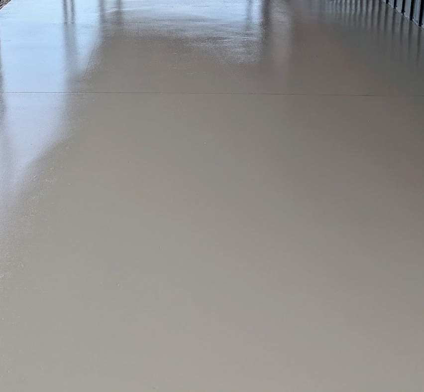 A group of construction workers are working on a concrete walkway.