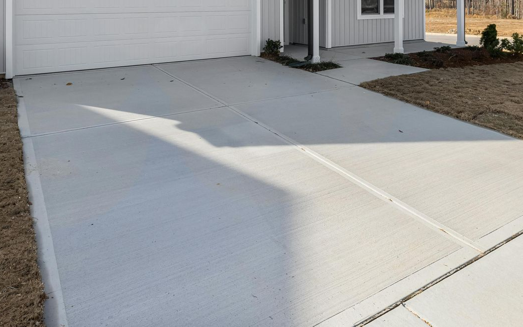 A group of construction workers are working on a concrete walkway.