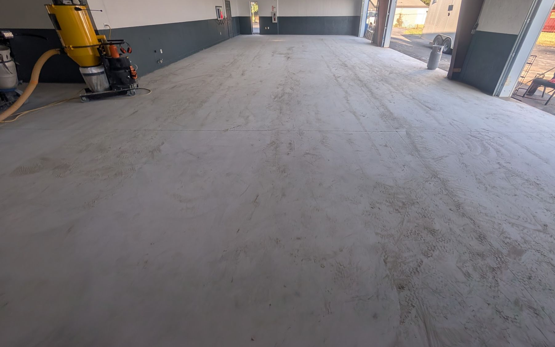 A group of construction workers are working on a concrete walkway.