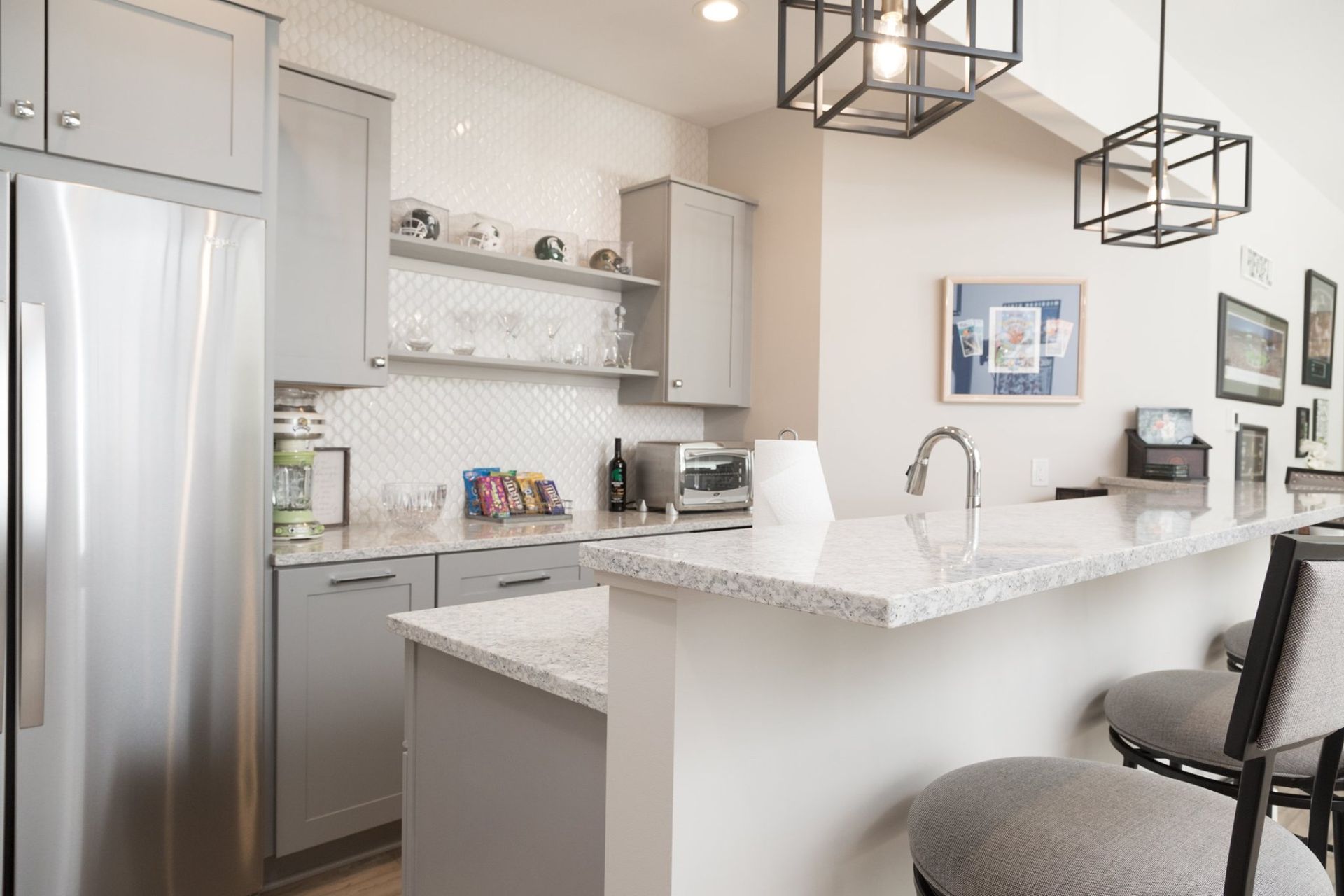 A kitchen with stainless steel appliances and granite counter tops.