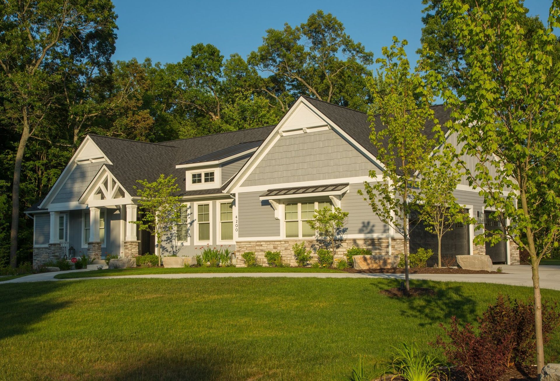 A large house with a lush green lawn in front of it
