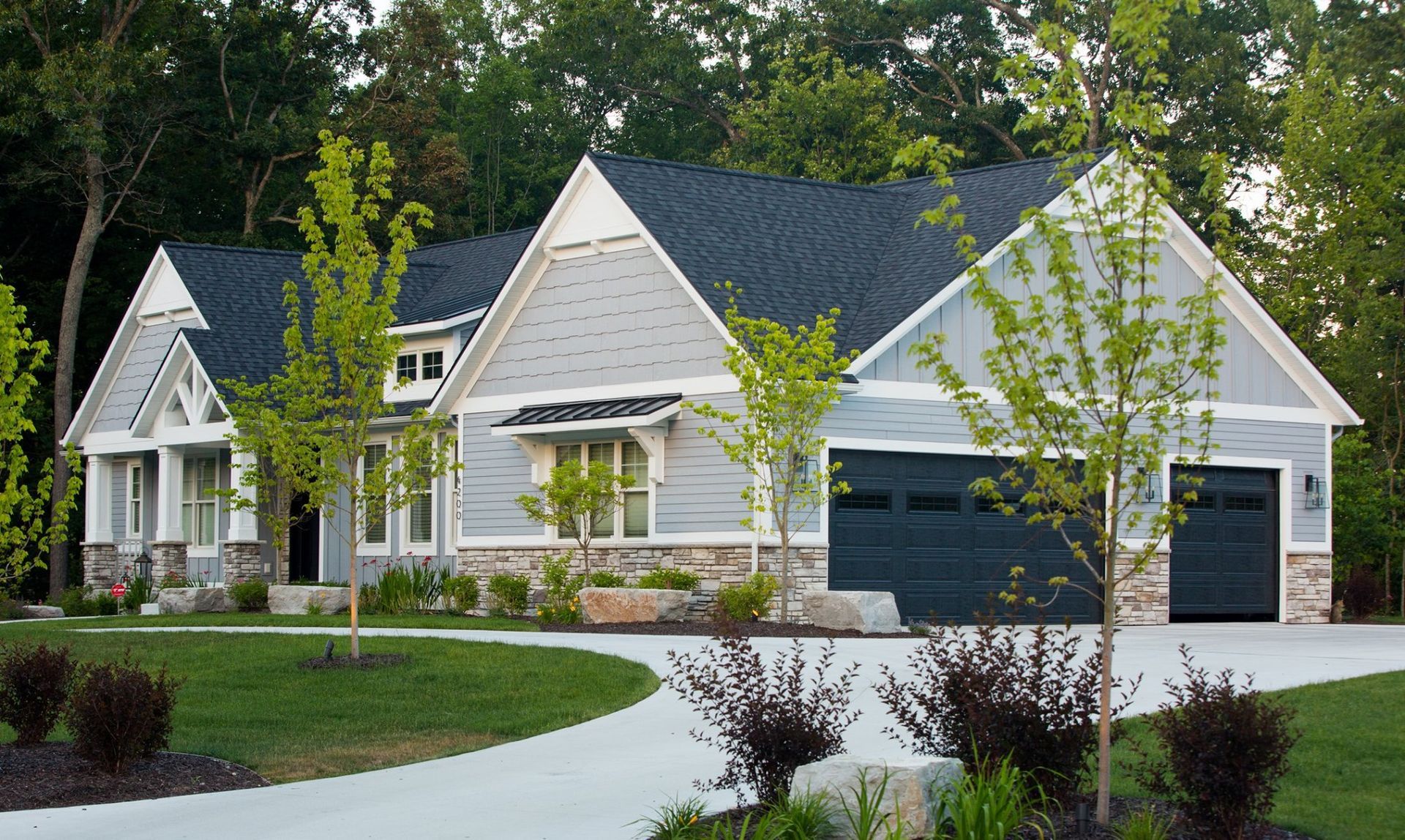 A large house with two garages and a driveway