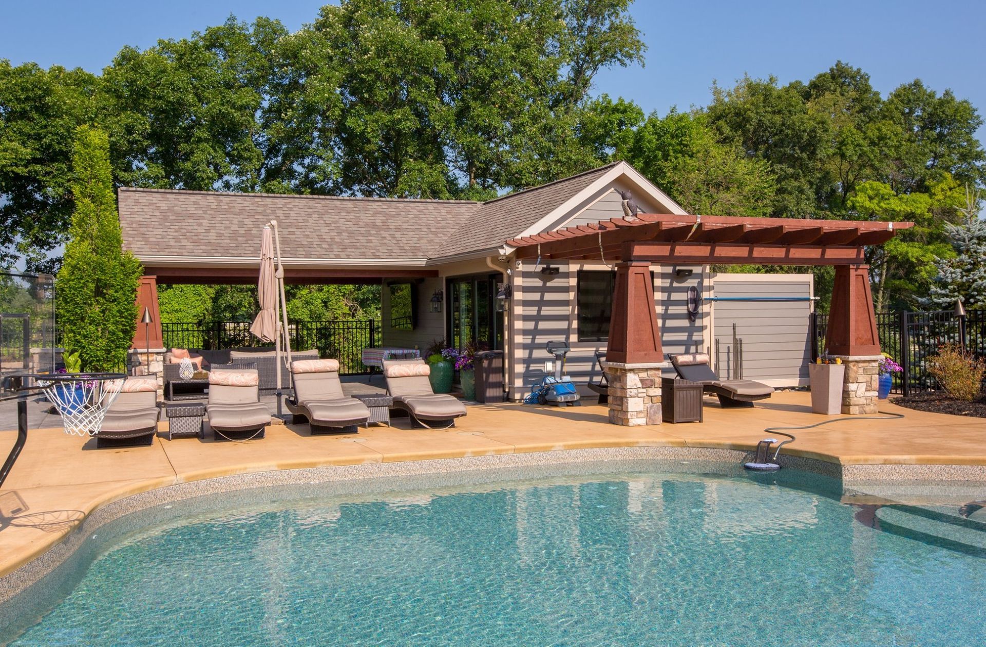 A large swimming pool with chairs and umbrellas around it