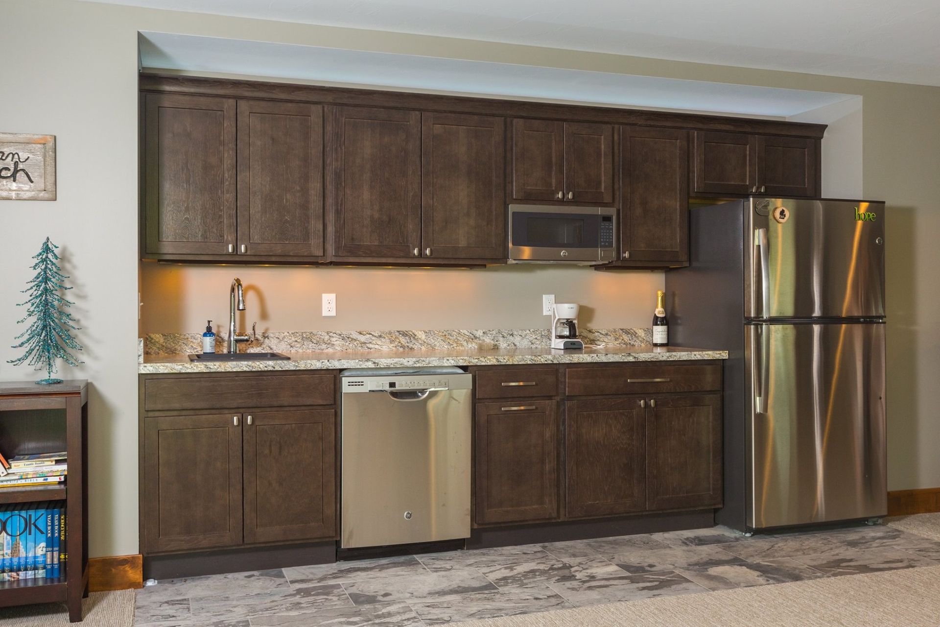 A kitchen with stainless steel appliances and wooden cabinets.