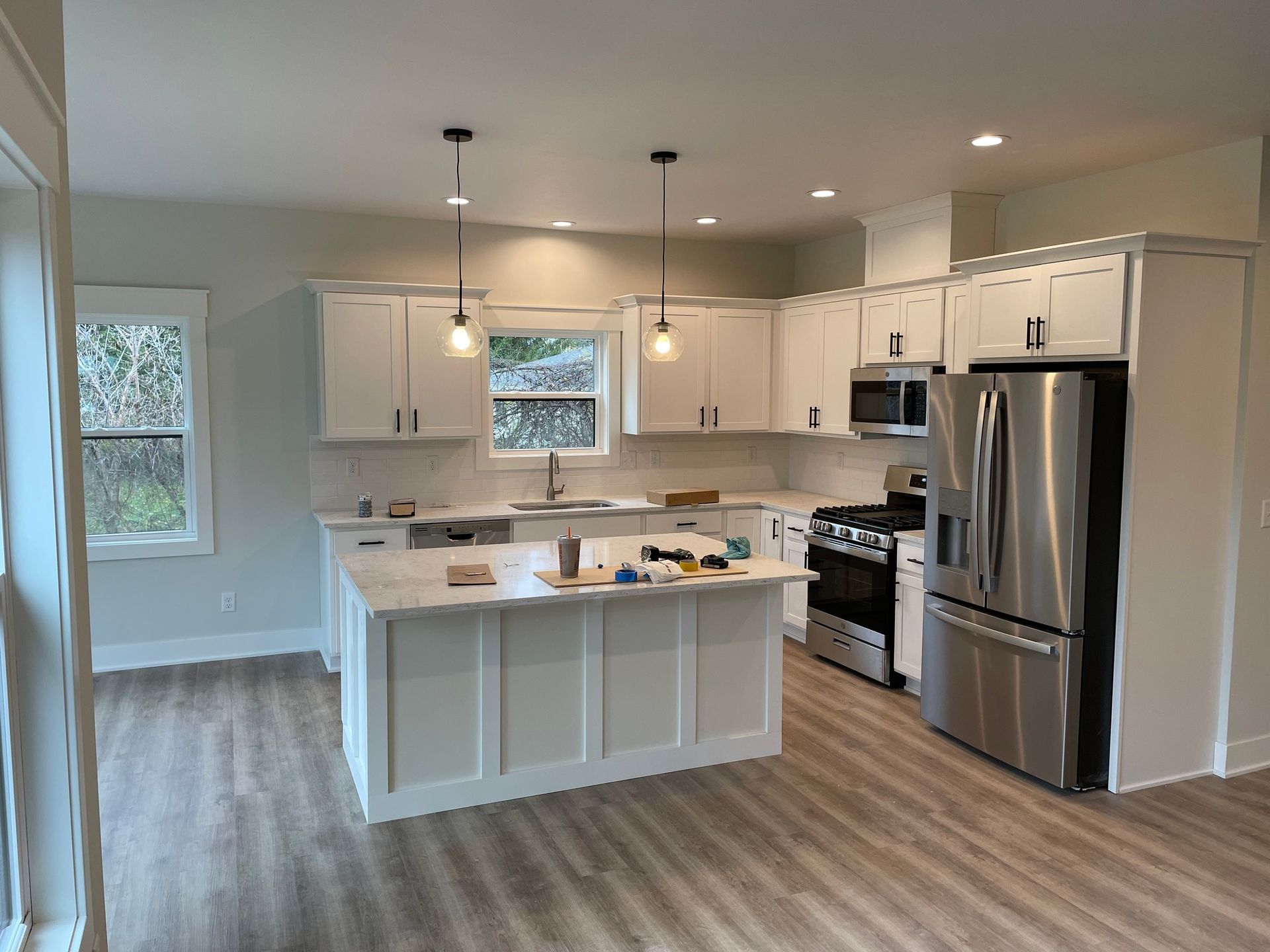 A kitchen with white cabinets and stainless steel appliances