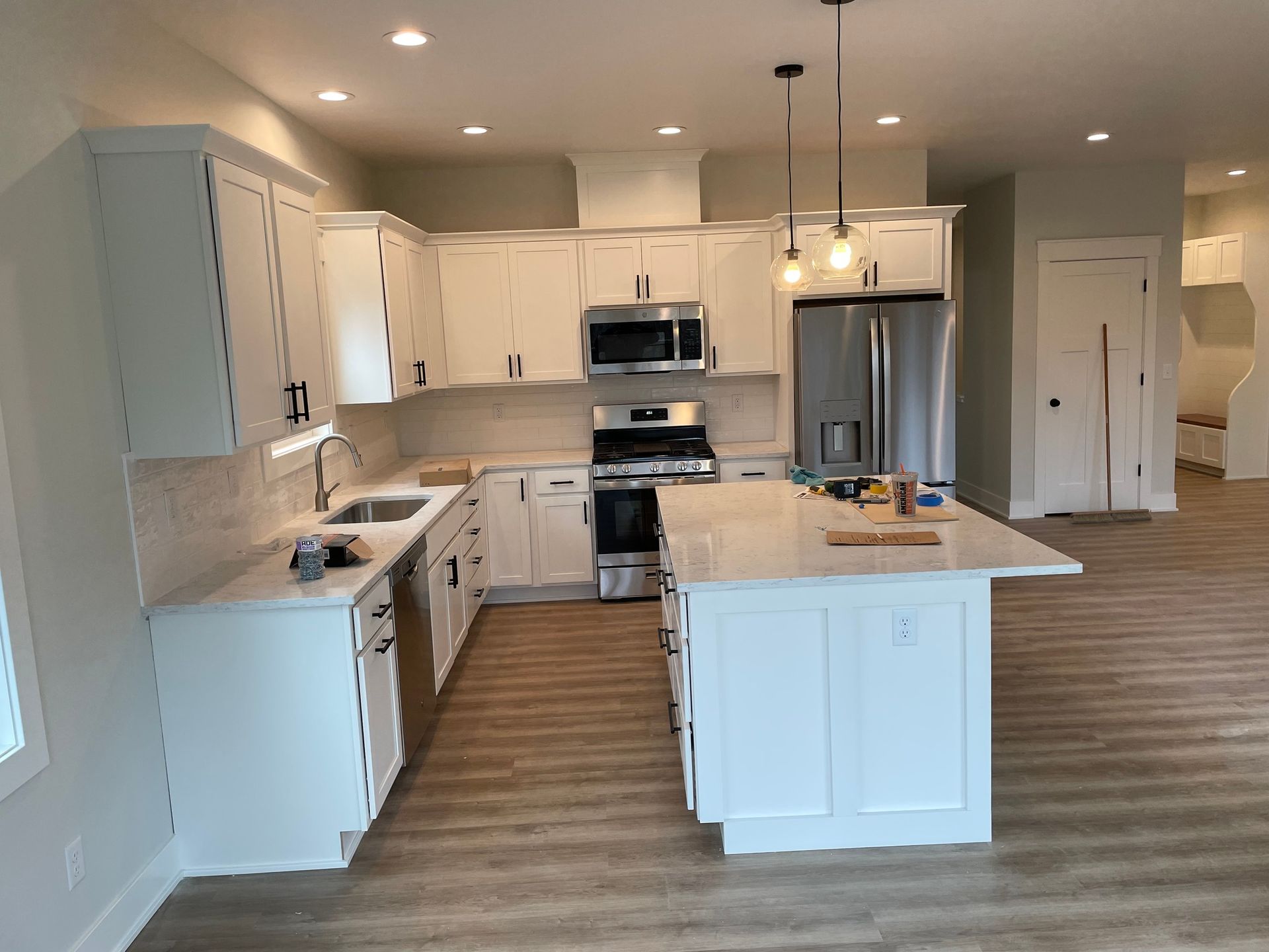 A kitchen with white cabinets and stainless steel appliances
