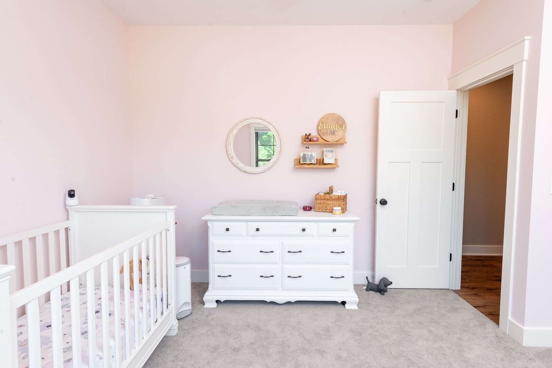 There is a crib and a dresser in the room.