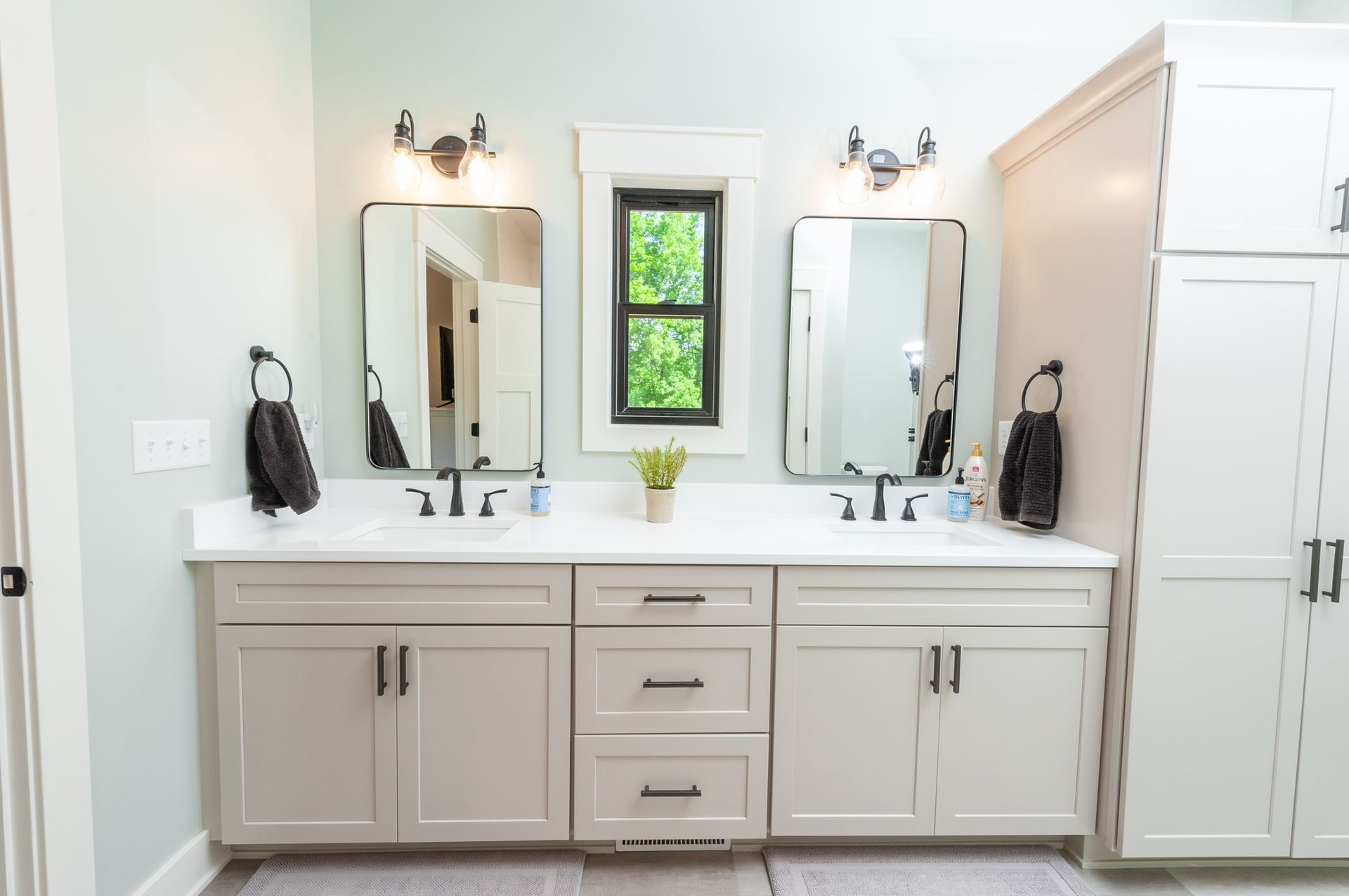 A bathroom with two sinks and two mirrors.