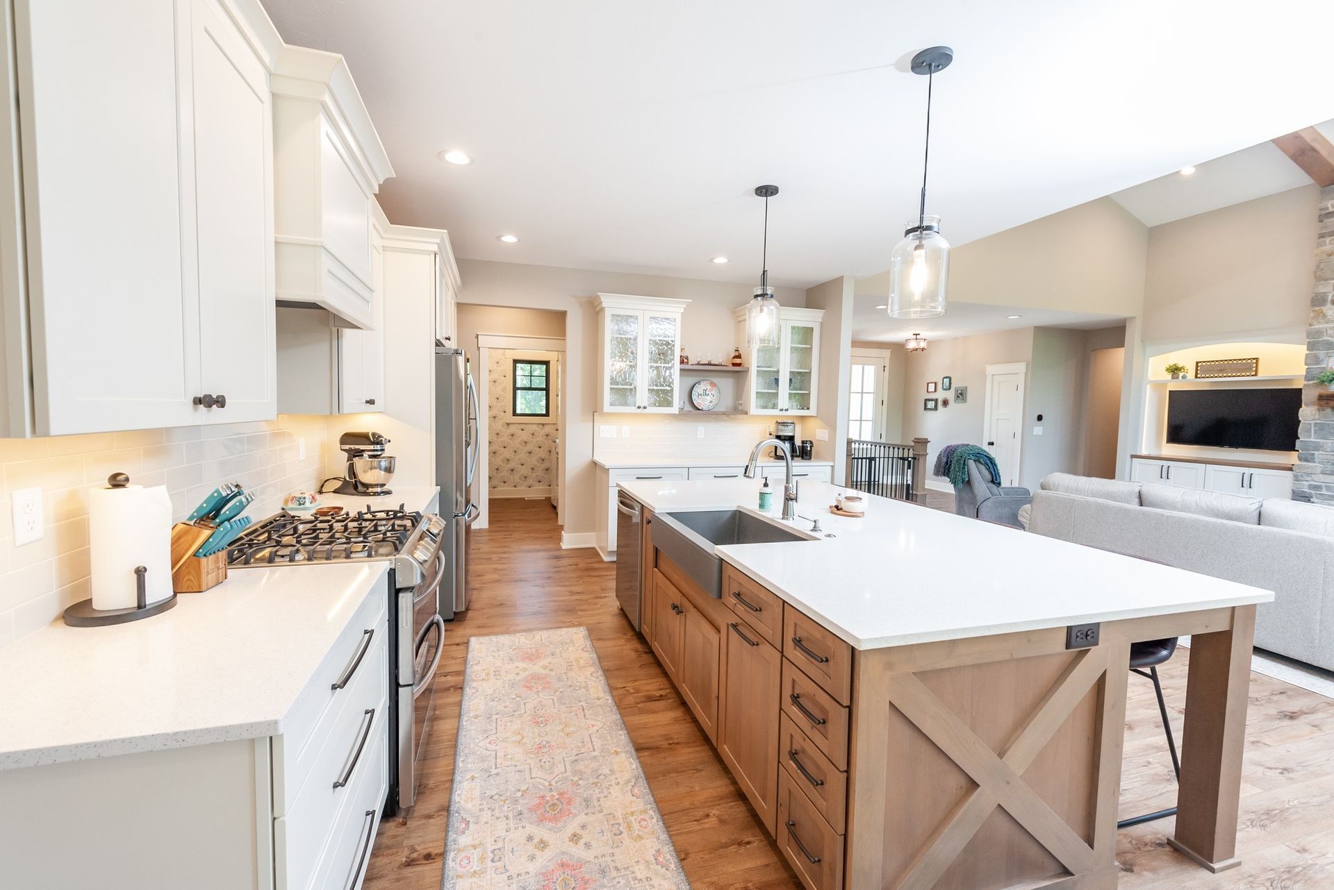 A kitchen with white cabinets and a large island in the middle.